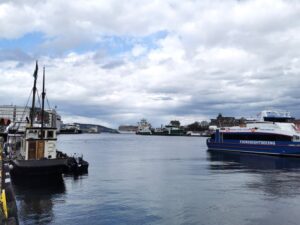 Looking down the harbour towards the outlet into the fjords, with cruise ships, fishing boats and touris boats lined up alongside