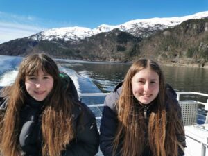 Matilda and Francesca enjoying the sun on the back of the fjord cruise boat