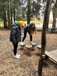 Twins helping one another in the adventure playground on Mt Fløyen