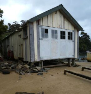 A sign of times past, a boat shed, broken windows, flaking paint