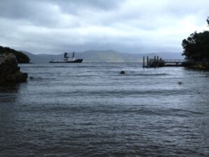 The gloomy weather in Paterson Inlet, the jetty we met Rakiura at and the super yacht