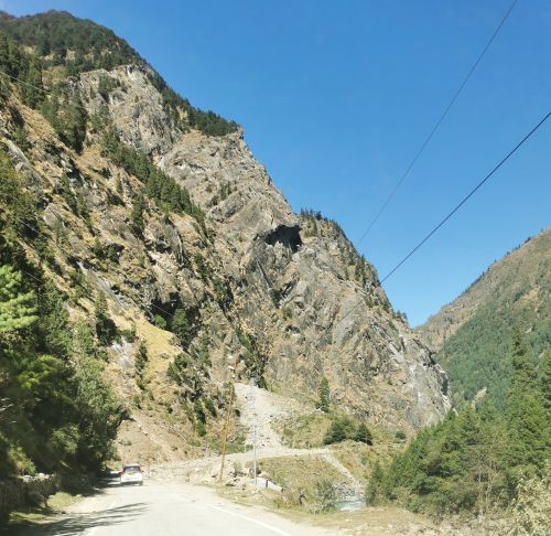 A car in front of us approaches some damaged road leading past a road slip on the way to Gangotri