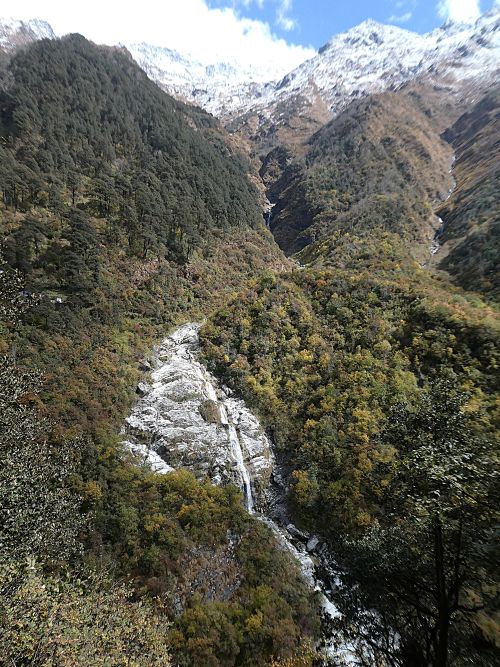 Fresh snow, high mountains, small waterfalls and autumn colours in the moutains to the side of Yamunotri Temple complex