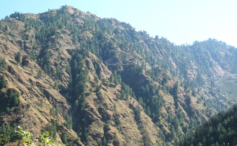 Houses and roads dwarfed by the size of the hills and forest across the valley from the road we travelled