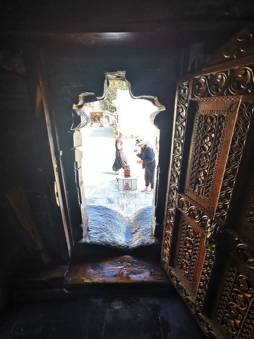 Looking out the door of the Shiva Temple Hatkoti and the highly carved door