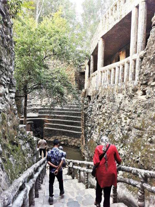 Strolling down a stairway to a pond in the Rock Garden Chandigarh