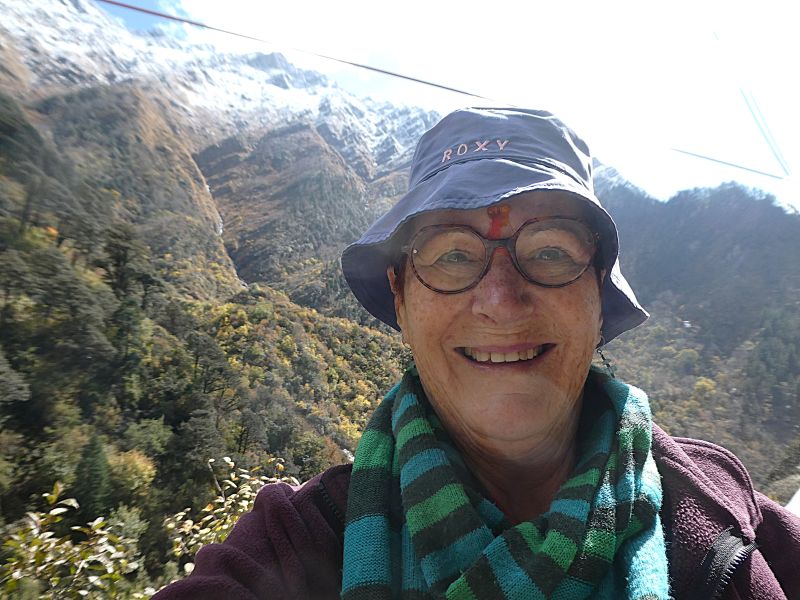 Teresa after the blessing at Yamunotri with the mountains beyond