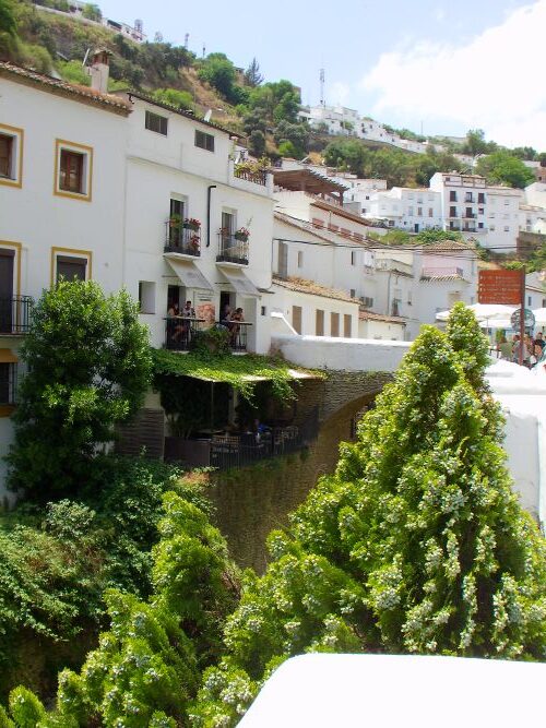 Along the river to the Juliet windows of Taberna La Telera 1860 by the bridge in Setenil de las Bodegas