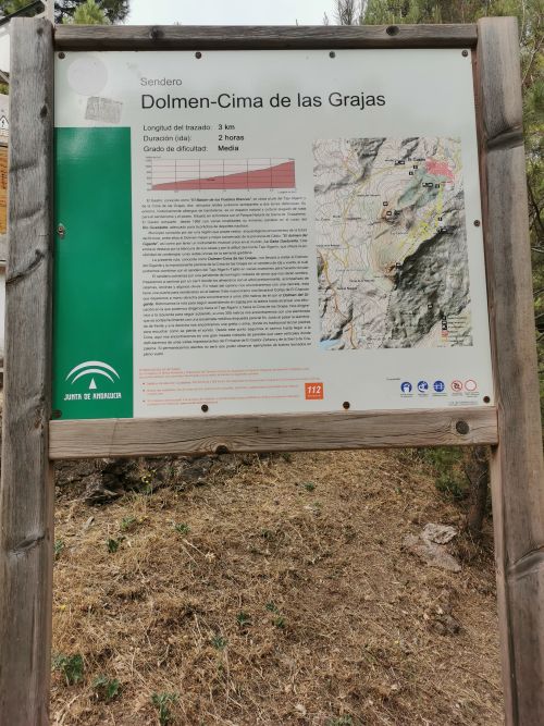 A signboard indicating the track to the Dolmen del Giganta and the Cima de las Grajas beyond