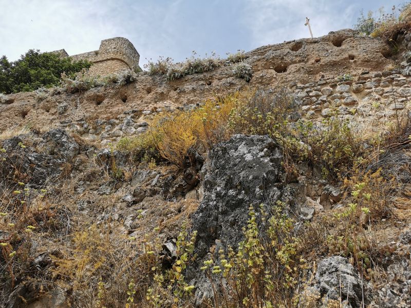 Looking up from the track to the castle on the hill, notice the old crumbling wall above the track