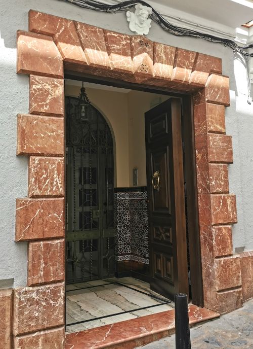 The decorated entrance way to a building on a street in Ubrique