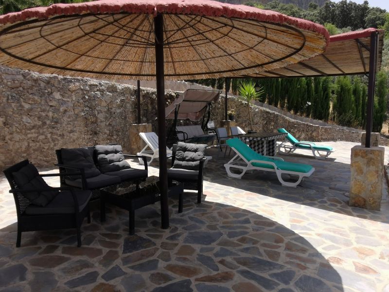 The relaxation area beside the pool at El Tajo