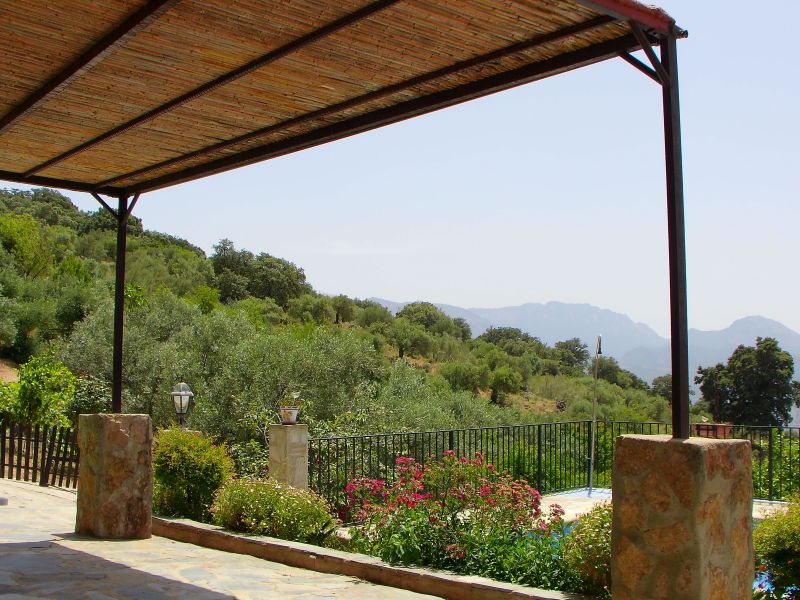 The shaded resting area above the swimming pool with a view to the Grazalema National Park mountains from El Tajo