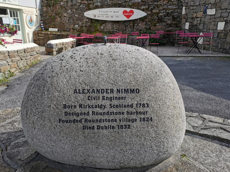 A memorial stone to Alexander Nimmo in Roundstone near a cafe