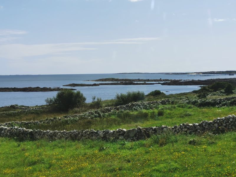 Fields wrapped in ancient stone walls by the ocean in Ireland