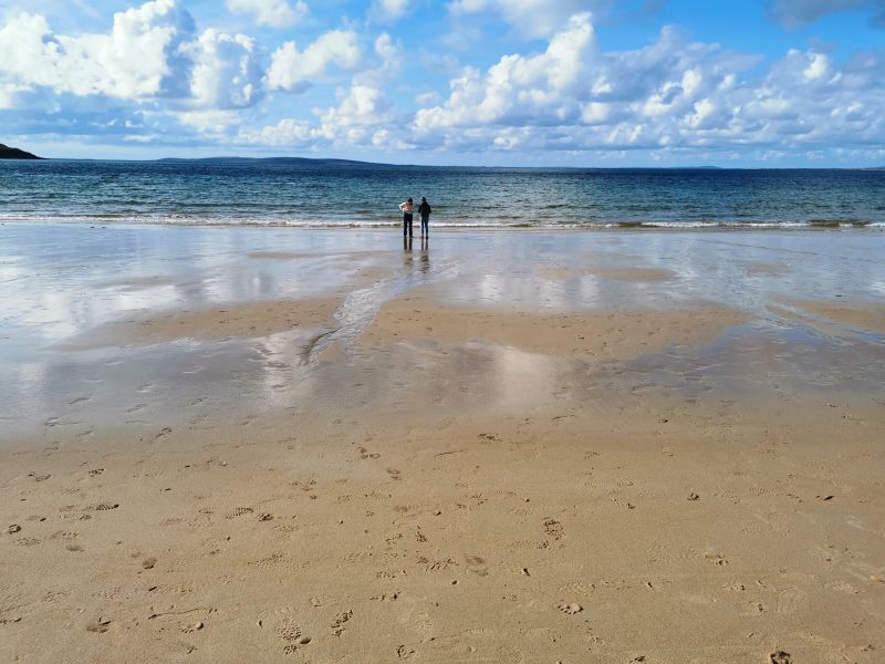 Francesca and Matilda on the wet sand on the beach at Dugort, Achill Island