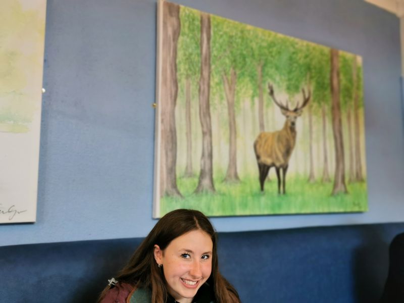 Francesca in the kitchen under the painting in a deer at Kylemore Abbey