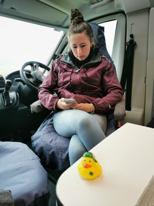 Our little plastic duck mascot, Cillian Murphy, in front of Francesca in the campervan