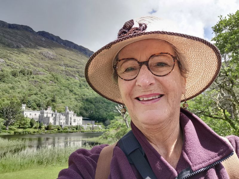 Teresa at Kylemore Abbey below the steep bluffs behind