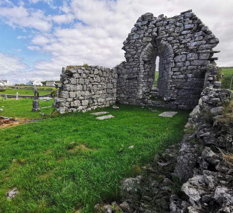 The crumbling church and cemetry near the village on the coast road in The Burren