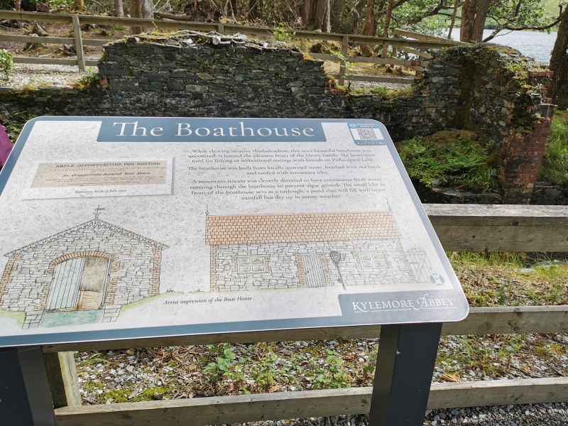 The crumbling remains of the boathouse and an information board at Kylemore Abbey
