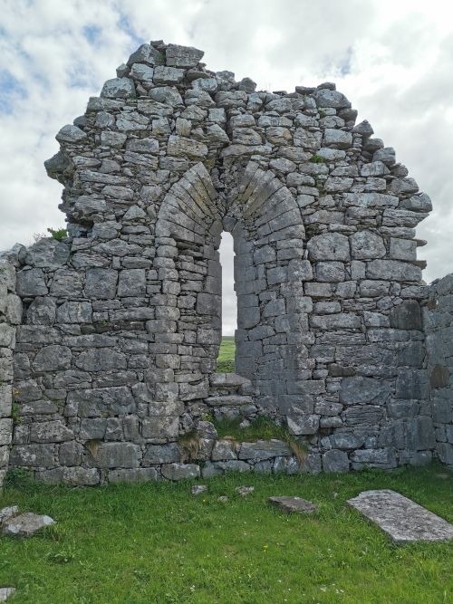 The thick walls and narrow window of the ruined church in The Burren
